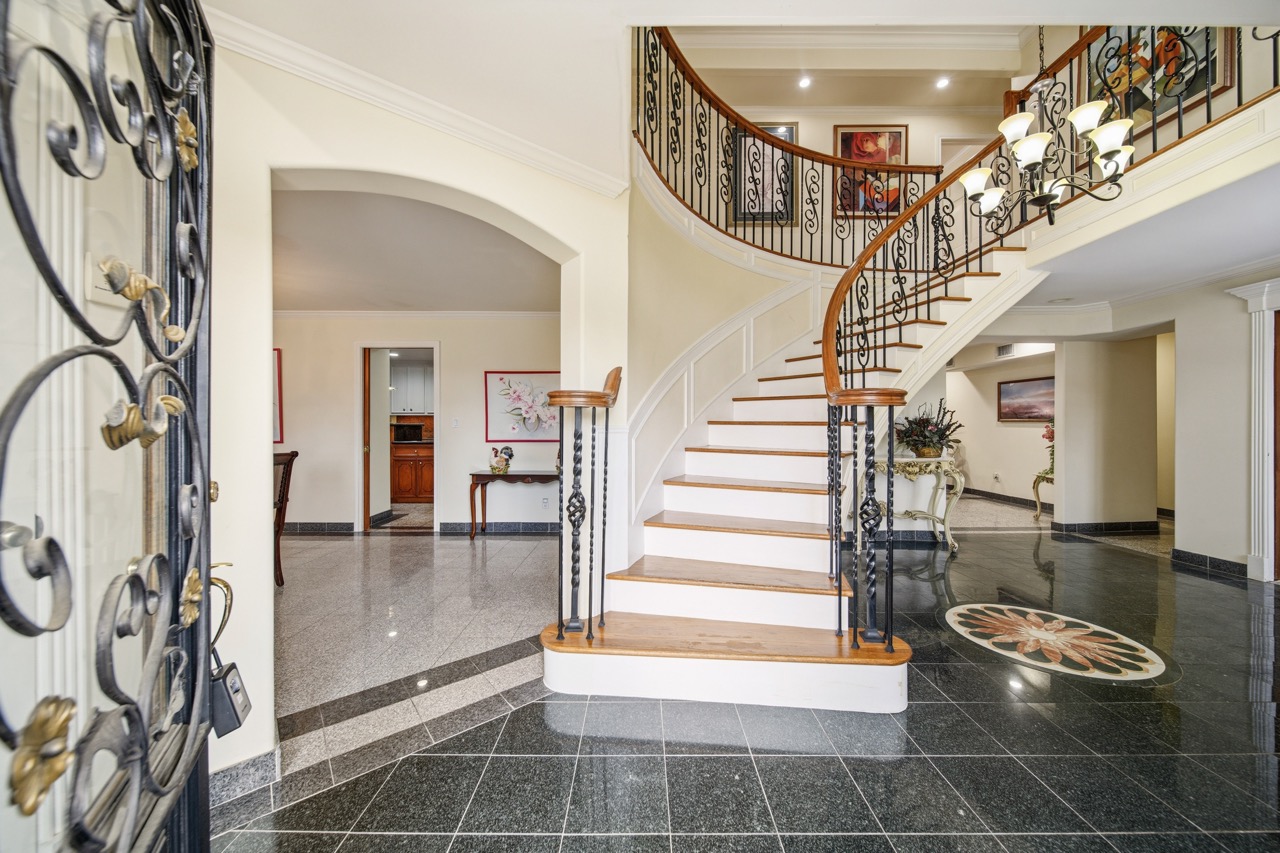Grand curved staircase and two-story foyer